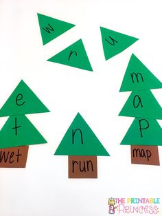 four trees cut out to spell the word merry and run