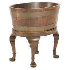 an old wooden bucket on stand with legs