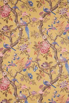 a yellow wallpaper with birds and flowers on the tree branches in front of it