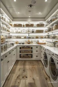 an organized laundry room with white cabinets and wood flooring is pictured in this image