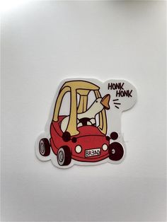 a sticker with an image of a man driving a red car and the words honk honk on it