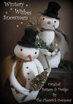 two snowmen are standing next to each other