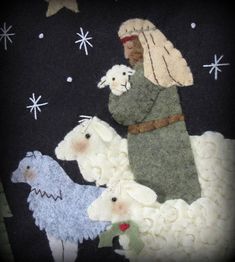 an image of the nativity scene with sheep and lambs on black fabric background