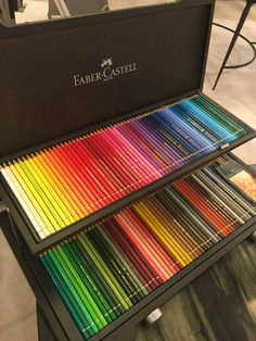 the faber - castel box is full of colored pencils in it's display case