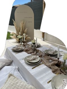 the table is set with plates, silverware and napkins for an elegant dinner