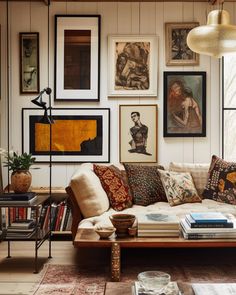 a living room filled with lots of furniture and pictures on the wall above it's coffee table