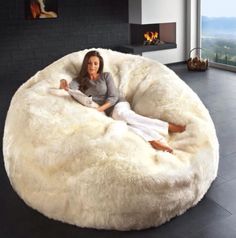 a woman sitting in a large white bean bag chair