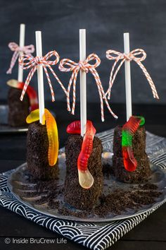 chocolate cake pops with candy worms on them