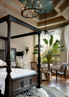 a bedroom with a zebra rug and four poster bed