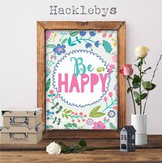 a wooden frame sitting on top of a table next to a vase with flowers in it