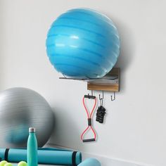 an exercise ball and gym equipment are hanging on the wall