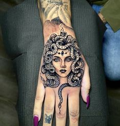 a woman's hand with a tattoo on it