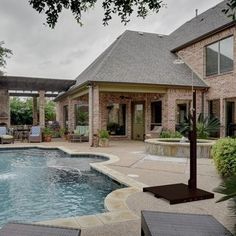 an outdoor swimming pool surrounded by patio furniture