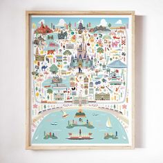 a framed poster with an illustrated map of the city and its landmarks on it's wall