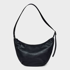 Bring a chic finishing touch to your everyday or dressy outfits with this Slouchy Crescent Sling Handbag from Universal Thread™. This unstructured handbag features a single zipper compartment to carry your phone, wallet, makeup essentials and other items. Plus, it has an interior zip pocket for any additional space you need. Designed in crescent shape and featuring a faux-suede finish in a solid hue, this handbag features an adjustable belt strap that make carrying it convenient and comfortable. Black Sling Bag, Crescent Shape, Target Style, Black Purses, Dressy Outfits, Satchel Handbags, Makeup Essentials, Adjustable Belt, Phone Wallet