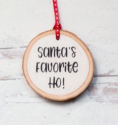 a wooden ornament with the words santa's favorite ho written on it