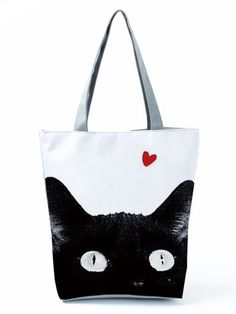 a black and white bag with a cat's face painted on the front side