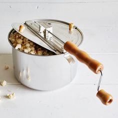 a silver pot filled with food next to a spatula