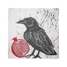 a black bird sitting on top of a pomegranate