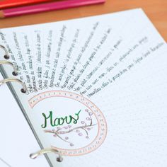 a close up of a notebook with writing on it