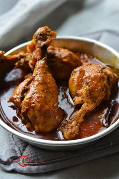 a bowl filled with chicken wings covered in sauce