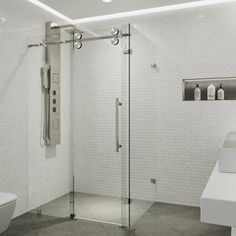 a white bathroom with a glass shower door