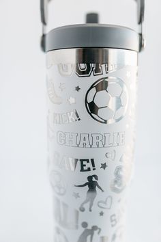 a stainless steel travel mug with the words, soccer and other sports related items on it