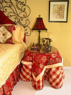 a bedroom with a bed, table and lamps