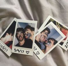 four polaroids with pictures of people sticking out of them on a white sheet