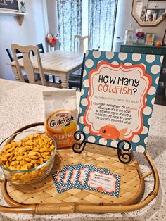 a tray with cereal and crackers on it next to a sign that says how many goldfish?