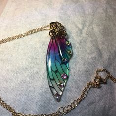 Fairy Wing Pendant And Chain Costume Jewelry. 20” Gold Tone Chain New Never Worn Iridescent Fairy Jewelry For Parties, Iridescent Fairy-style Jewelry For Parties, Iridescent Fairy Style Jewelry For Party, Multicolor Fairy Style Jewelry Gift, Fairy Style Multicolor Jewelry For Gifts, Fairy Style Multicolor Jewelry Gift, Multicolor Fairycore Jewelry For Gifts, Fairycore Multicolor Jewelry For Gifts, Fairy Pendant