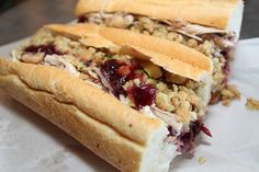 two sandwiches with cranberry sauce and nuts on them