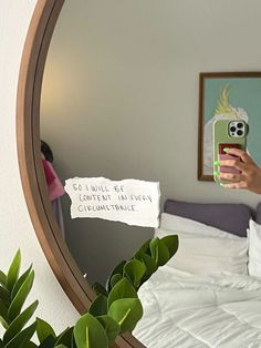 a person taking a selfie in front of a mirror with a cell phone on it