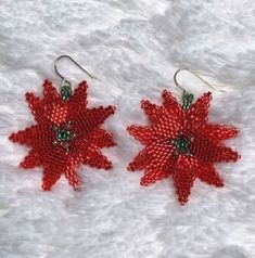 Looking for something to match that Christmas sweater? These festive metallic red Poinsettia earrings may be just the ticket. Created from glass Delica beads, fireline and sterling French hooks. Makes a great hostess gift or stocking stuffer. Poinsettia Earrings, Red Poinsettia, Delica Beads, Stocking Stuffer, Poinsettia, Hostess Gifts, Christmas Sweater, Beading Patterns, Cute Designs