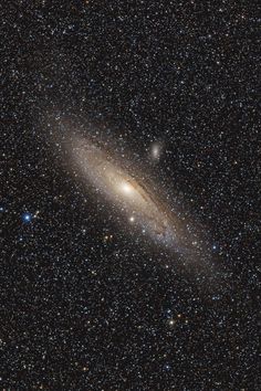 an image of a very large galaxy in the night sky with stars and space dust