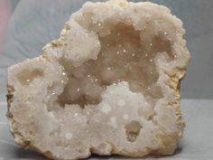 "This white agate geode grew in the shape of a heart and had a huge sugary druzy inside.  It's a very beautiful piece and would make a great decorative item.  Does not come with a stand.  It measures approx. 4\" across, 3\" tall, 1 1/2\" deep, and weighs 7.8 oz.  White Agate - harmonizes an individual's feminine and masculine sides, helping the body release toxins and building the immune system. It is also improves concentration and analytical frames of mind, as well as releases traumas and provides the courage to trust. If you have any questions, please contact me. Since crystals are formed by Mother Nature, and depending on the material, marks/inclusions/cracks/holes may appear in or on the stone, but they are all natural and not damaged items. Always check the photos and dimensions befo White Natural Stones Geode For Healing, Handmade White Agate Geodes, White Natural Stone Geodes For Spiritual Use, White Natural Stone Geodes For Healing, White Agate Geodes For Healing, Unique White Geodes As Gift, Unique White Geodes For Gift, Unique Handmade White Geodes, Feminine And Masculine