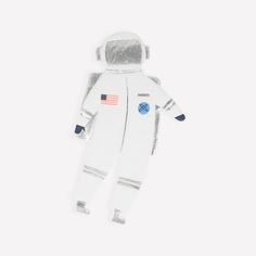 an astronaut doll is laying on the ground with its eyes closed and one hand in it's pocket