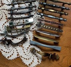 several different types of knives on a lace doily