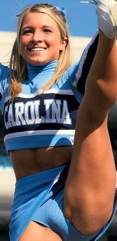 a cheerleader is posing for the camera