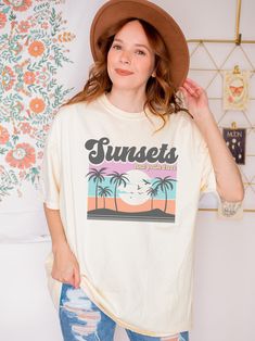 Retro-inspired Sunset T-Shirt that is perfect for adding a touch of nostalgia to your wardrobe. Our designs are professionally printed, ensuring that the vibrant colors and intricate details of the sunset design are captured perfectly. Made from 100% cotton (except for heather colors, which are a cotton-poly blend), our Sunset T-Shirts are incredibly comfortable to wear, and the relaxed fit ensures that you'll feel at ease all day long. Our shirts are designed to be a unisex fit, making them a great option for anyone looking for a comfortable and stylish shirt. To ensure that you find the perfect fit, please check the size chart provided in the images. Whether you're wearing our Sunset T-Shirt for a day out with friends or a relaxing evening at home, you'll love the comfortable and stylish Trendy Oversized Tops With Custom Print, Vintage Summer Tops With Custom Print, Vintage Custom Print Tops For Summer, Retro Oversized Shirt With Letter Print, Oversized Retro Graphic Print Shirt, Oversized Retro Shirt With Graphic Print, Oversized Graphic Tee With Custom Print, Retro Shirt With Letter Print And Relaxed Fit, Retro Relaxed Fit Shirt With Letter Print