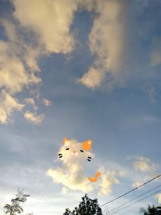 a cat shaped kite flying in the sky