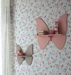 two butterfly shaped shelves on the wall in a girls'room with floral wallpaper