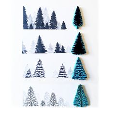 three small trees are on the wall next to each other, and one is made out of paper