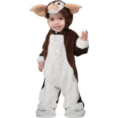 a baby dressed in a monkey costume standing up with one hand on his hip and the other