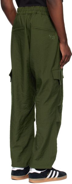 Straight-leg recycled polyester twill cargo pants. · Bungee-style drawstring at elasticized waistband · Four-pocket styling · Zip-fly · Flap pocket at front · Pleats at knees · Concealed bungee-style drawstring at cuffs · Cargo pocket at outseams · Logo bonded at back · Unlined Supplier color: Green Spring Military Style Parachute Pants With Cargo Pockets, Spring Military Parachute Pants With Cargo Pockets, Spring Combat Cargo Pants, Military Style Parachute Pants For Spring Streetwear, Techwear Parachute Pants With Patch Pockets, Combat Parachute Pants With Patch Pockets For Streetwear, Military Nylon Cargo Pants With Cargo Pockets, Green Utility Parachute Pants With Functional Pockets, Military Style Nylon Pants With Pockets