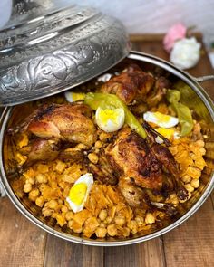 a large pot filled with food on top of a wooden table