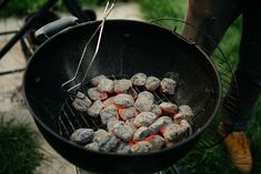 a person cooking food on an outdoor grill