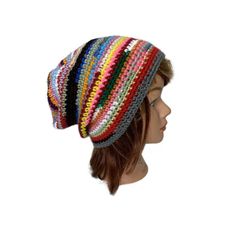 a woman's head wearing a multicolored knitted beanie hat on top of a mannequin