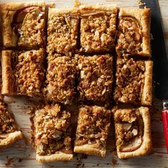 an apple pie cut into squares on top of a cutting board