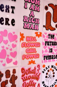 many different types of stickers on a wall with pink and orange hearts in them